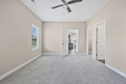 a view of empty room with ceiling fan