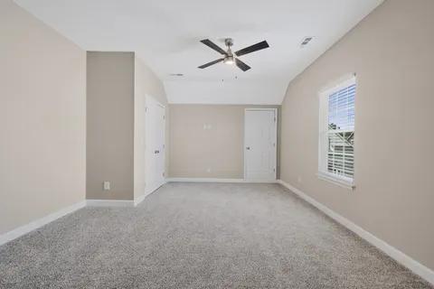 a view of a livingroom with a ceiling fan and window