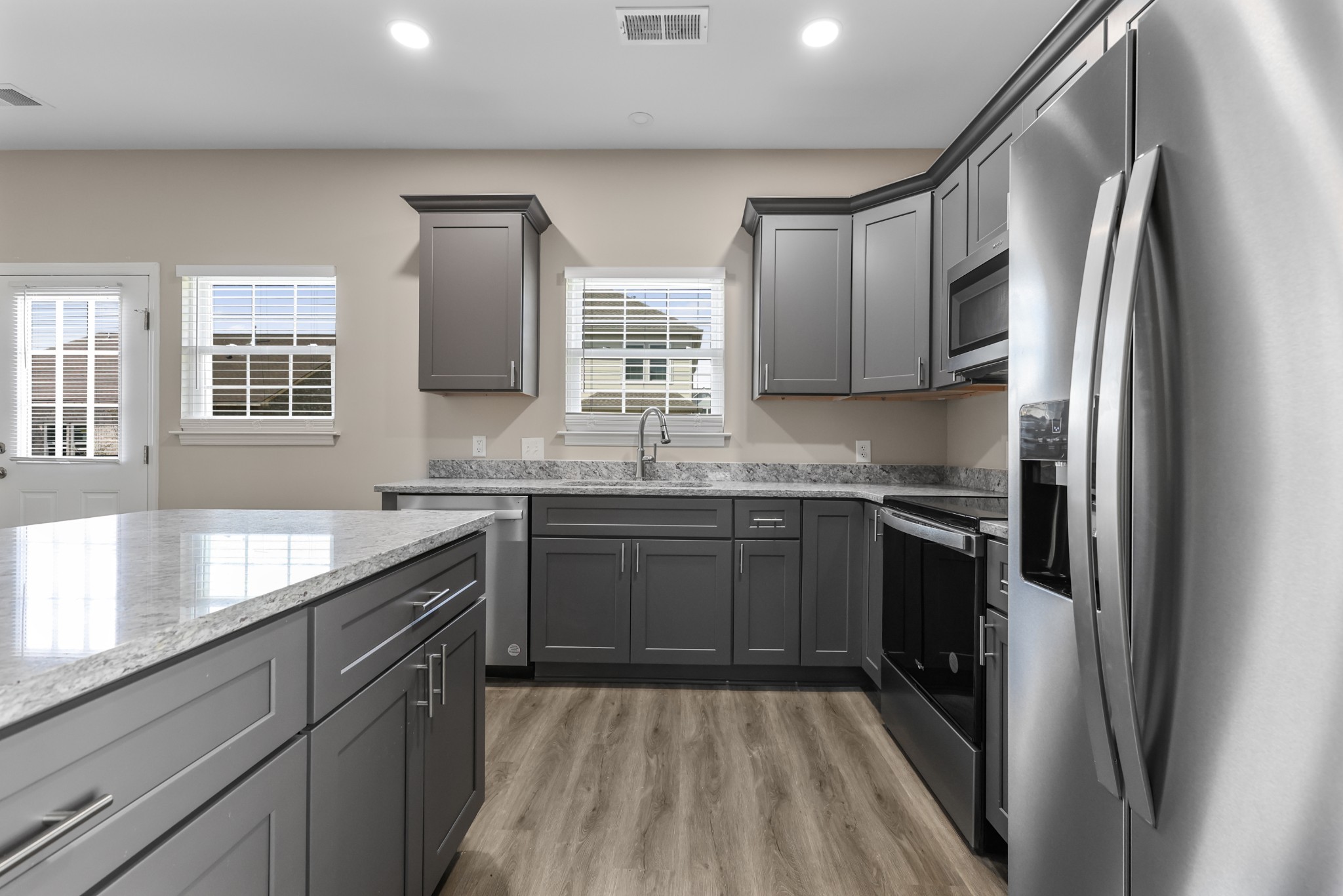 871 Blessing Way Gallatin, TN 37066 - Photo 6 of 25 a kitchen with stainless steel appliances granite countertop a refrigerator and a sink