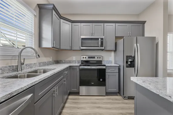 a kitchen with a sink stove and refrigerator