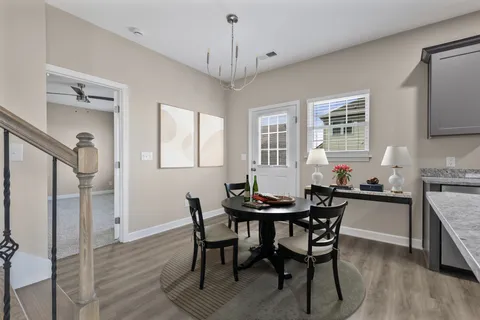 a view of a dining room with furniture and wooden floor