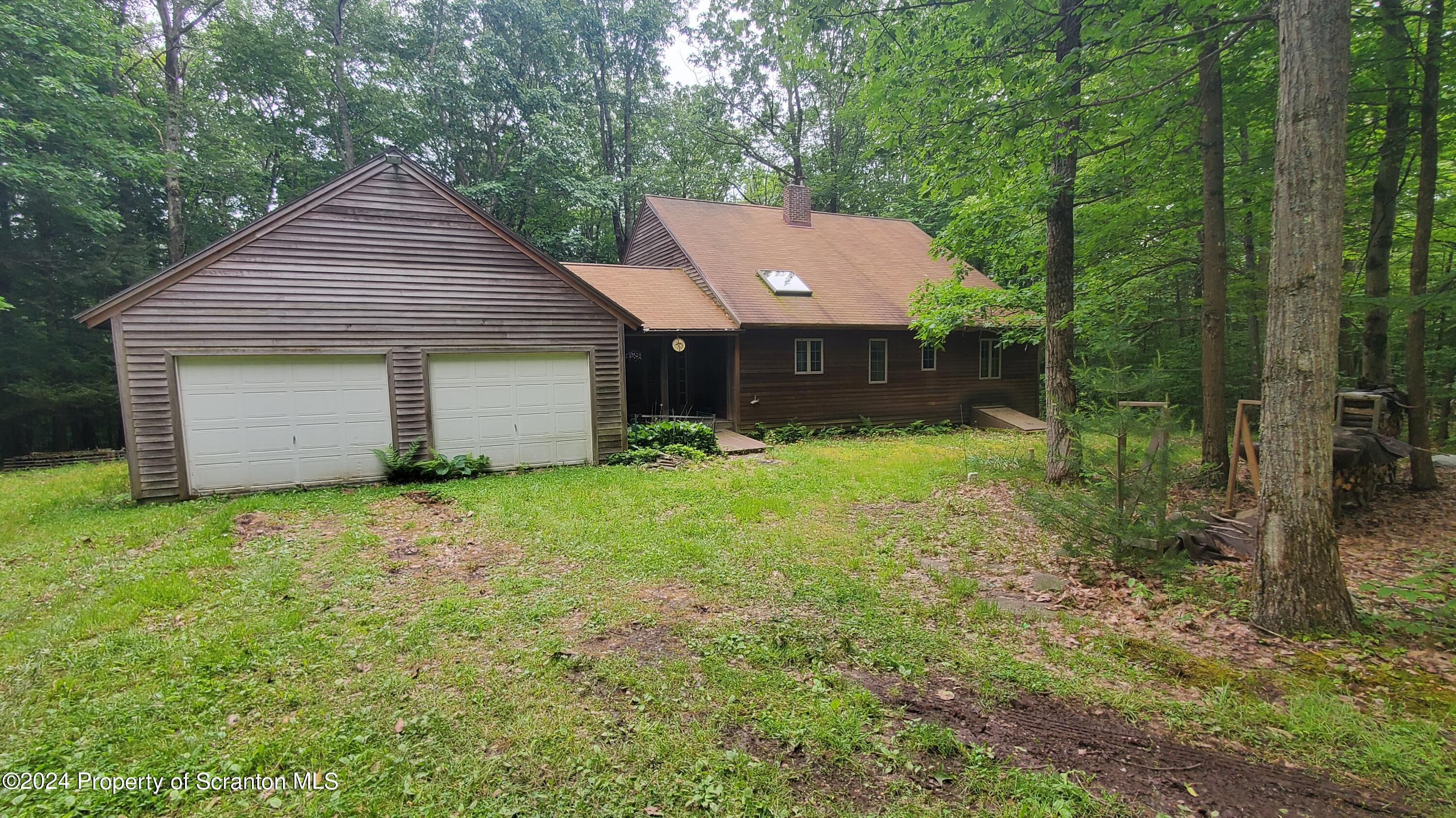1508 Graham Holw Road Hallstead, PA 18822 - Photo 1 of 32 a backyard of a house with plants and large tree
