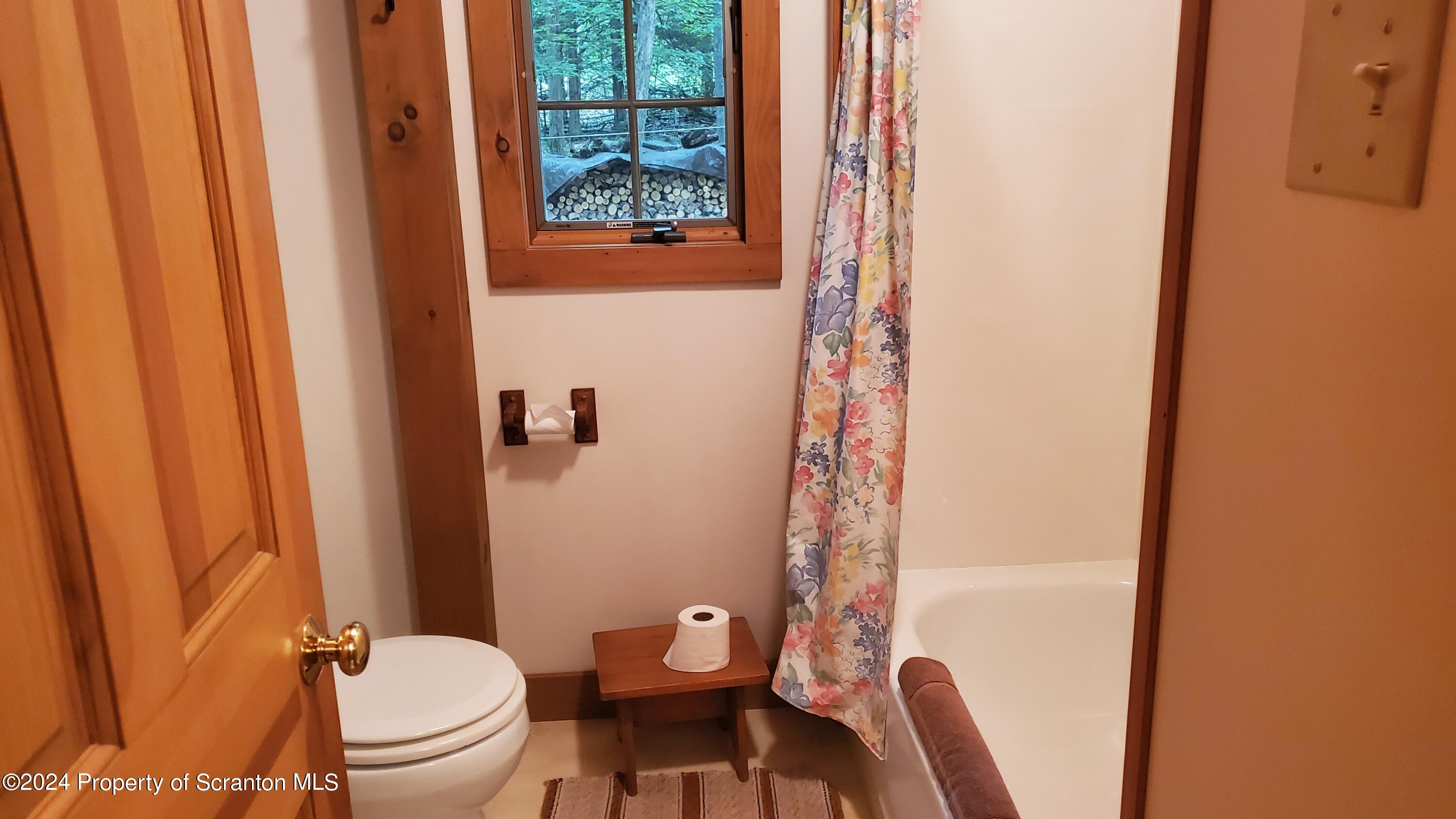 1508 Graham Holw Road Hallstead, PA 18822 - Photo 14 of 32 a white toilet sitting next to a shower curtain