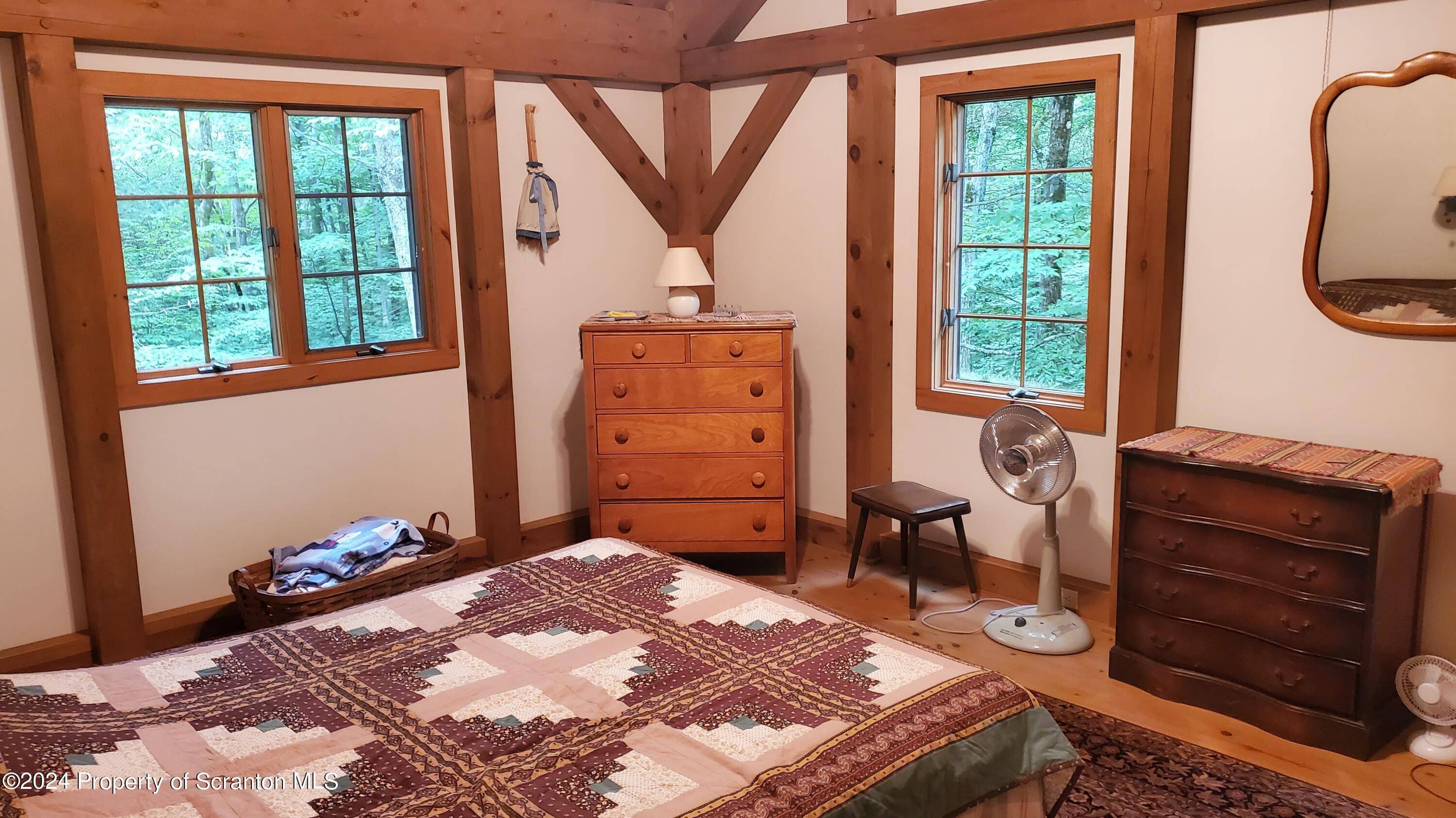 1508 Graham Holw Road Hallstead, PA 18822 - Photo 18 of 32 a bedroom with a bed and a dresser next to a window