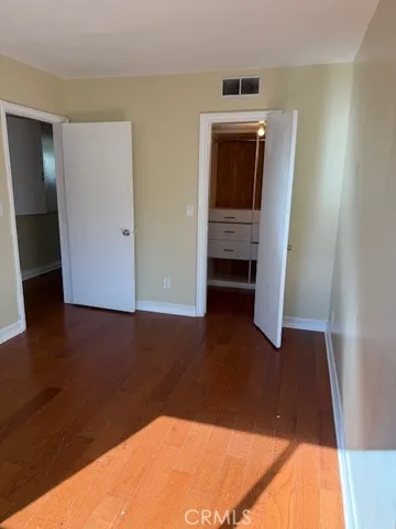 a view of a livingroom with wooden floor and closet