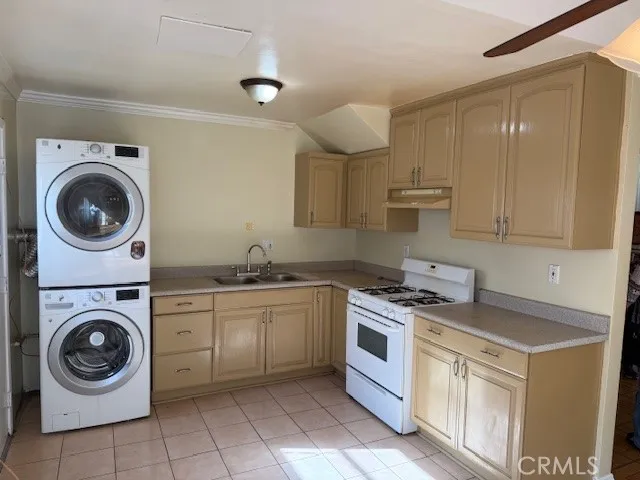 a kitchen with cabinets washer and dryer