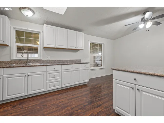 a view of a kitchen with wooden floor