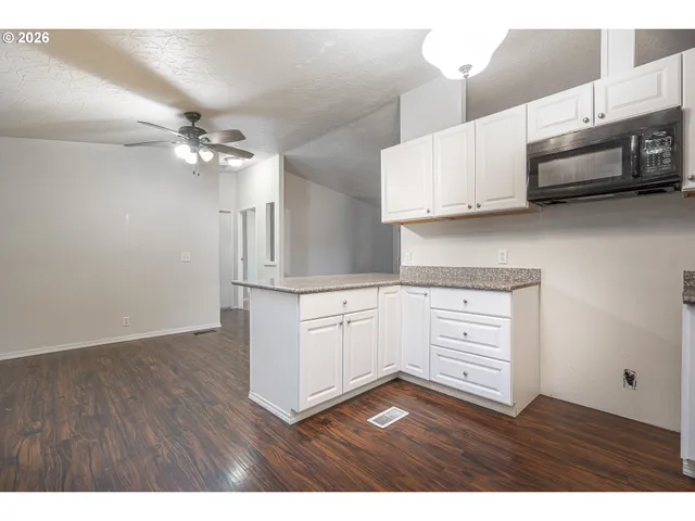 a kitchen with stainless steel appliances white cabinets and a sink