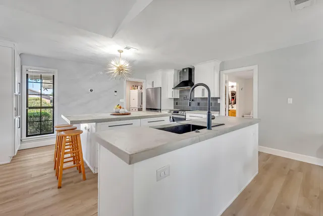 a large kitchen with a table and chairs
