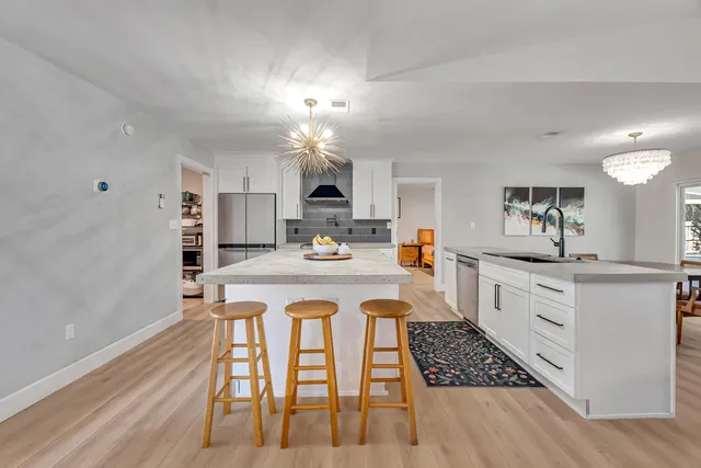 a kitchen with a sink a counter space and cabinets