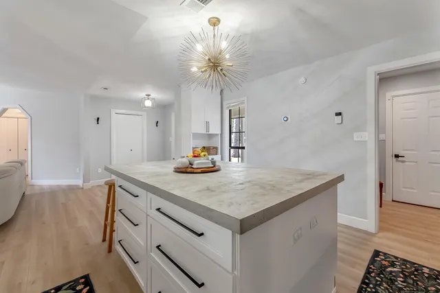 a bedroom with a bed and glass door