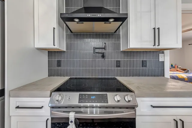 a bedroom with a bed and a dresser in it