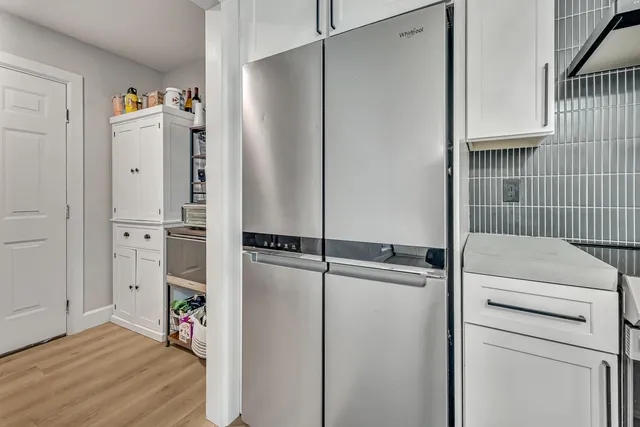a bathroom with a double vanity sink mirror and bathtub