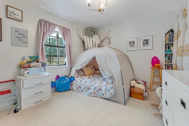 a living room with furniture and floor to ceiling windows
