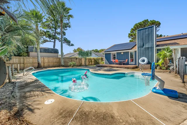 a view of a house with swimming pool and sitting area