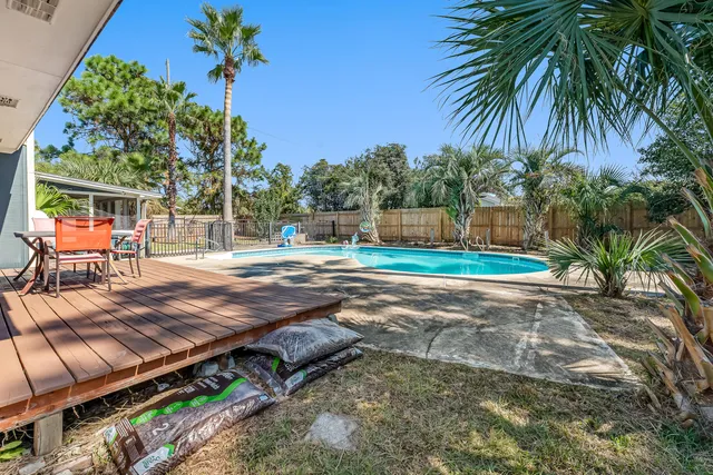 a view of a swimming pool with a house in the background