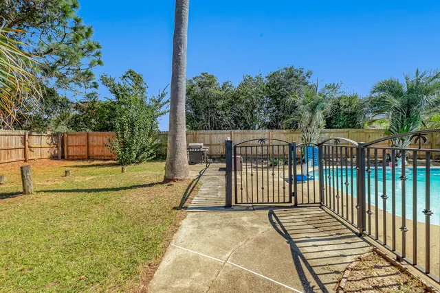 a view of a swimming pool with a yard