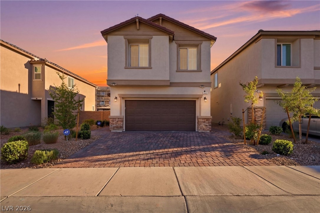 1921 Miller Ridge Avenue North Las Vegas, NV 89031 - Photo 3 of 26 This residence showcases a modern facade with an attached garage, offering convenient parking.