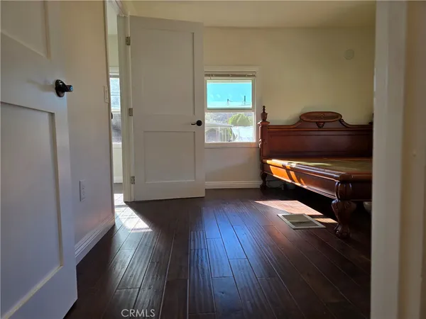 a view of hallway with wooden floor and stairs