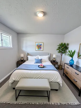 a bedroom with a bed and a potted plant