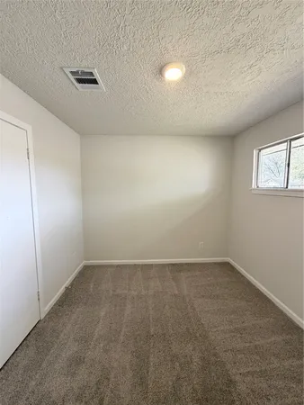 an empty room with a empty space and windows