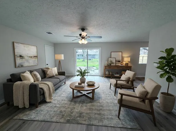 a living room with furniture a large window and a chandelier