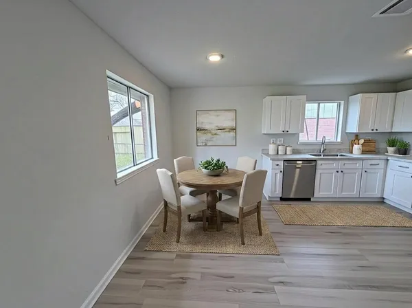 a view of a dining room with furniture and window