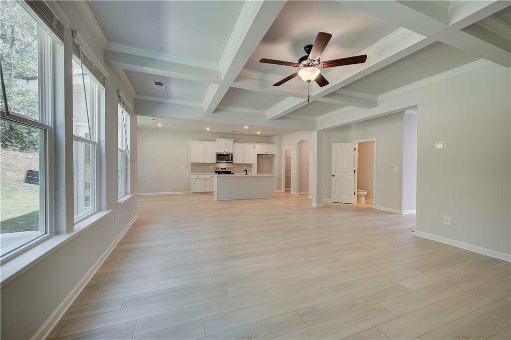 119 St Anne's Place Covington, GA 30016 - Photo 15 of 30 a view of empty room with wooden floor and fan