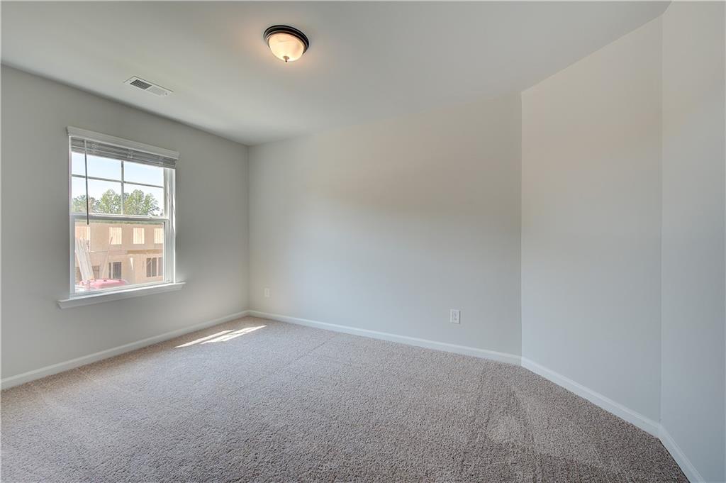 119 St Anne's Place Covington, GA 30016 - Photo 19 of 30 an empty room with windows