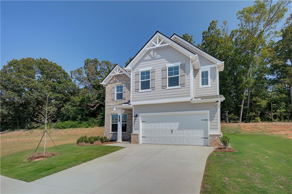 119 St Anne's Place Covington, GA 30016 - Photo 2 of 30 a front view of a house with a yard and garage