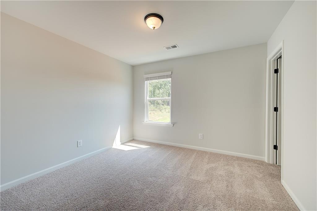 119 St Anne's Place Covington, GA 30016 - Photo 21 of 30 a view of an empty room with a window