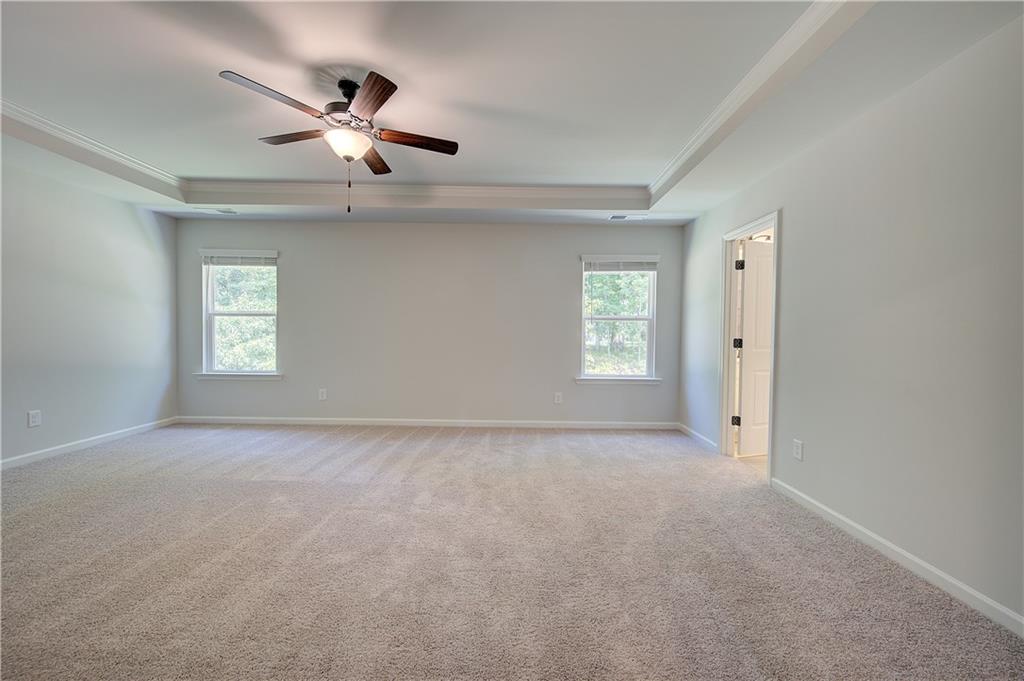 119 St Anne's Place Covington, GA 30016 - Photo 22 of 30 an empty room with windows and fan