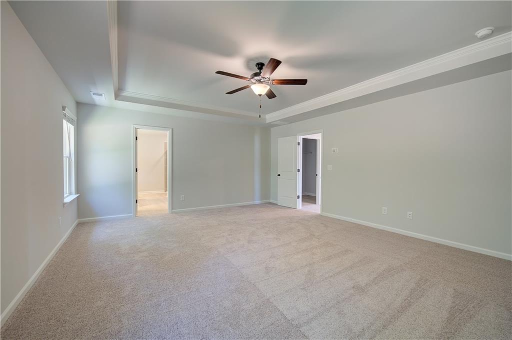 119 St Anne's Place Covington, GA 30016 - Photo 23 of 30 a view of a big room with a ceiling fan and a ceiling fan
