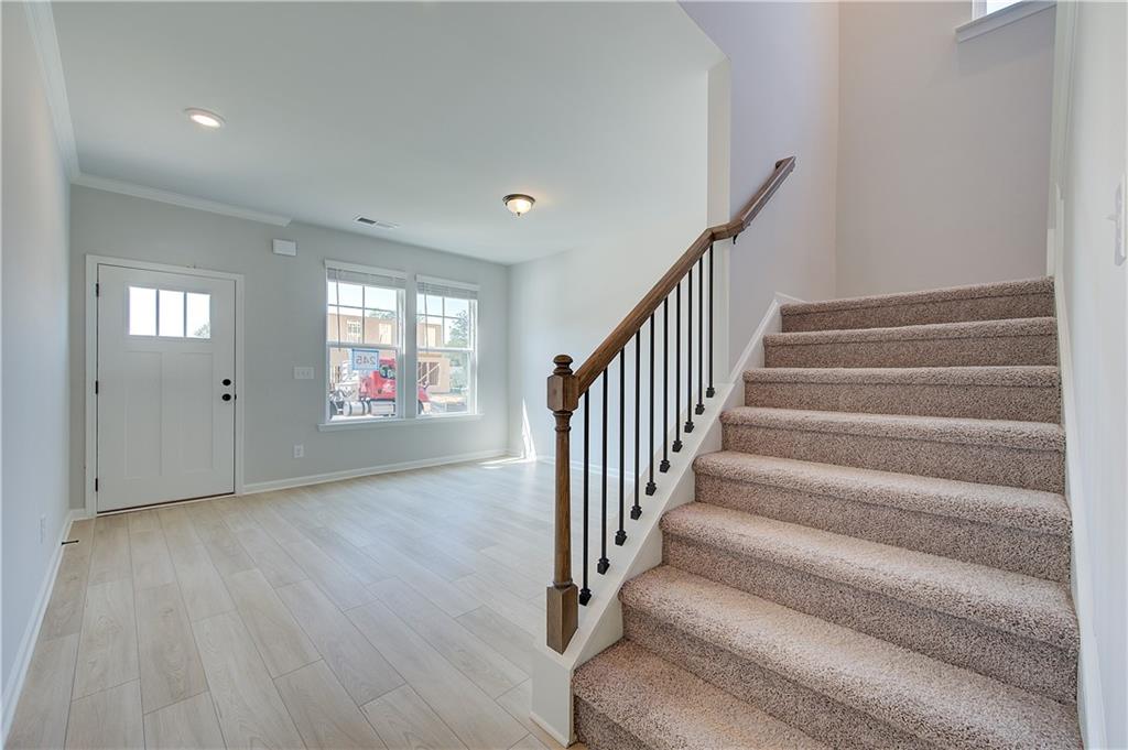 119 St Anne's Place Covington, GA 30016 - Photo 6 of 30 a view of an entryway with wooden floor