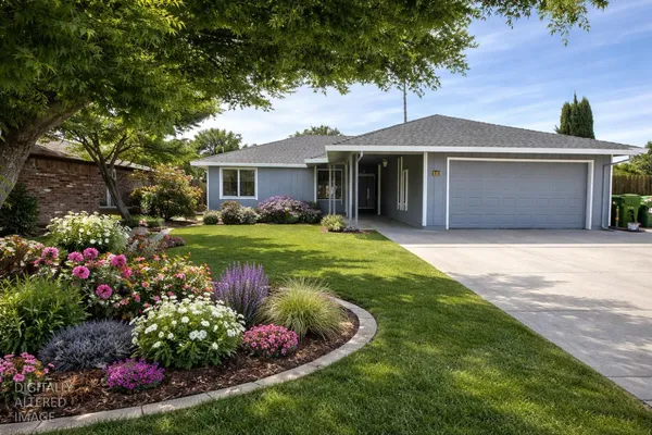 a front view of a house with a yard and potted plants