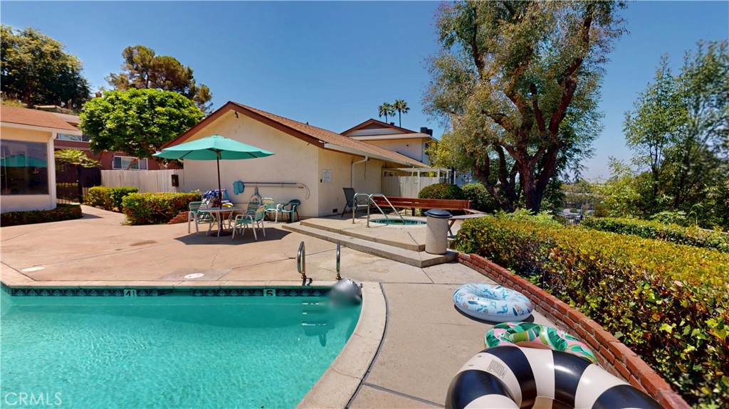1354 Shadow Lane Fullerton, CA 92831 - Photo 18 of 65 a view of a patio with couches table and chairs under an umbrella with a fire pit