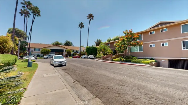 a view of a patio with table and chairs potted plants