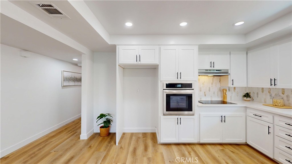 1354 Shadow Lane Fullerton, CA 92831 - Photo 25 of 65 a kitchen with white cabinets and stainless steel appliances