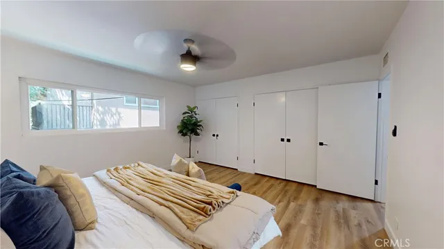 a bedroom with a bed and a potted plant