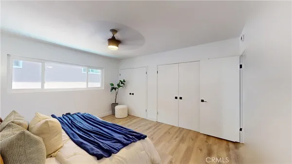 a view of a dining room with furniture a potted plant and wooden floor