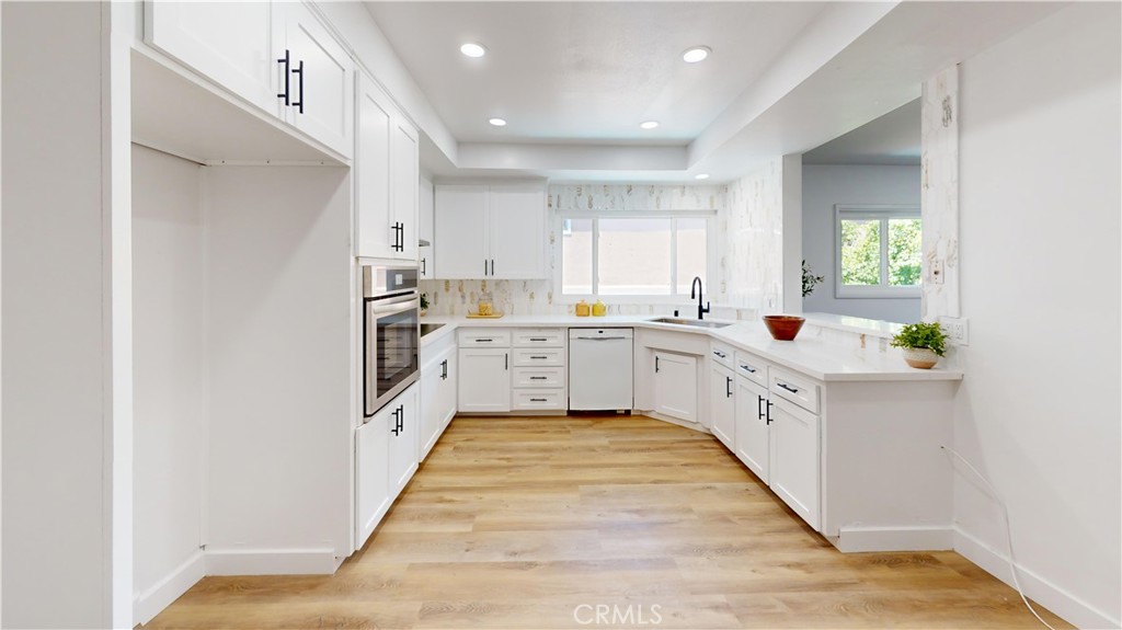 1354 Shadow Lane Fullerton, CA 92831 - Photo 61 of 65 a large white kitchen with cabinets and a window