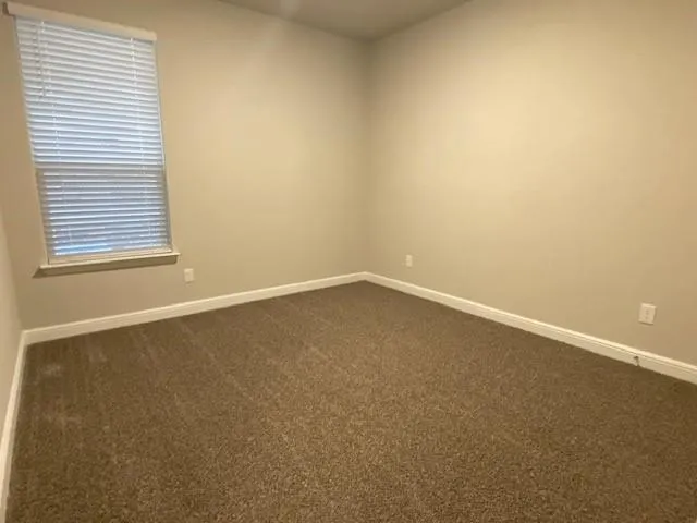 an empty room with closet area