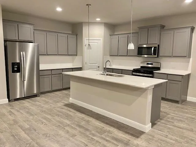 a kitchen with a sink a stove and cabinets