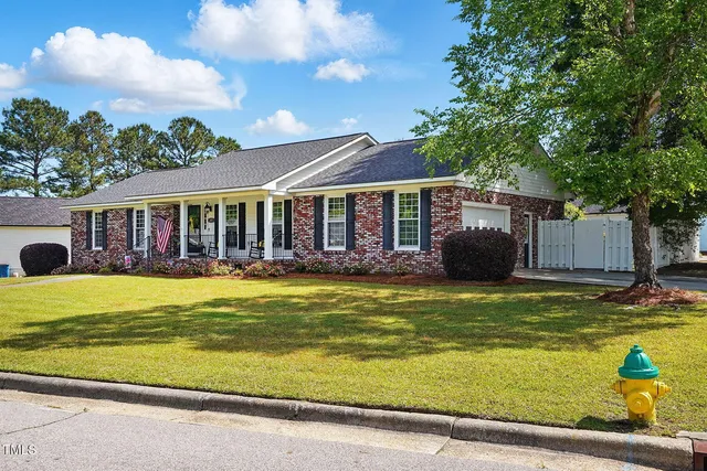a view of a house with swimming pool and a yard