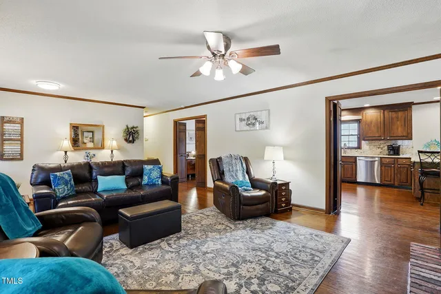 a living room with furniture and wooden floor