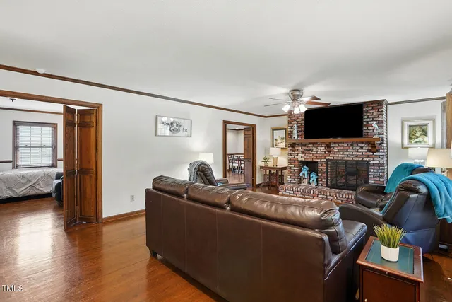 a living room with furniture a fireplace and a flat screen tv
