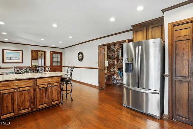 a kitchen with stainless steel appliances granite countertop a refrigerator and a sink