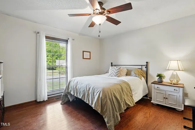 a bedroom with a bed and a ceiling fan