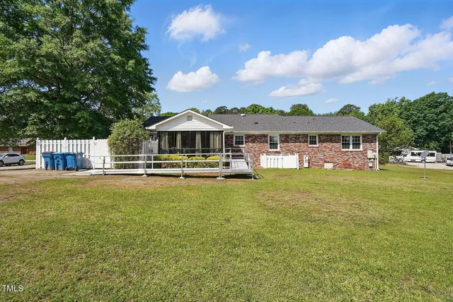 a front view of a house with swimming pool having outdoor seating