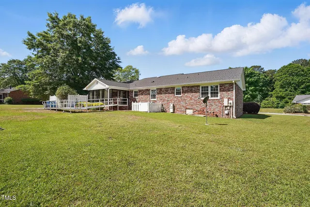 a view of house with outdoor space and swimming pool